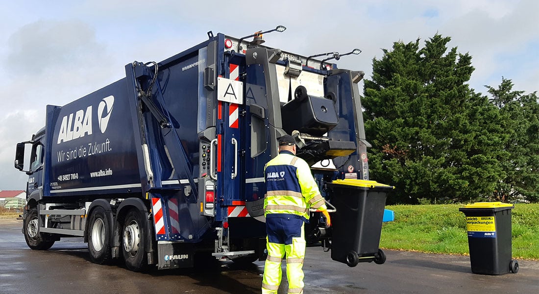 Mitarbeiter entleert Tonne in das ALBA-Abfall-Fahrzeug